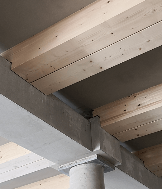 Modulare Holz-Hybrid-Bauweise: Geschoßdecken aus vorgefertigten Holz-Beton-Verbundelementen; Kerven übertragen die auftretenden Schubkräfte in das Holz